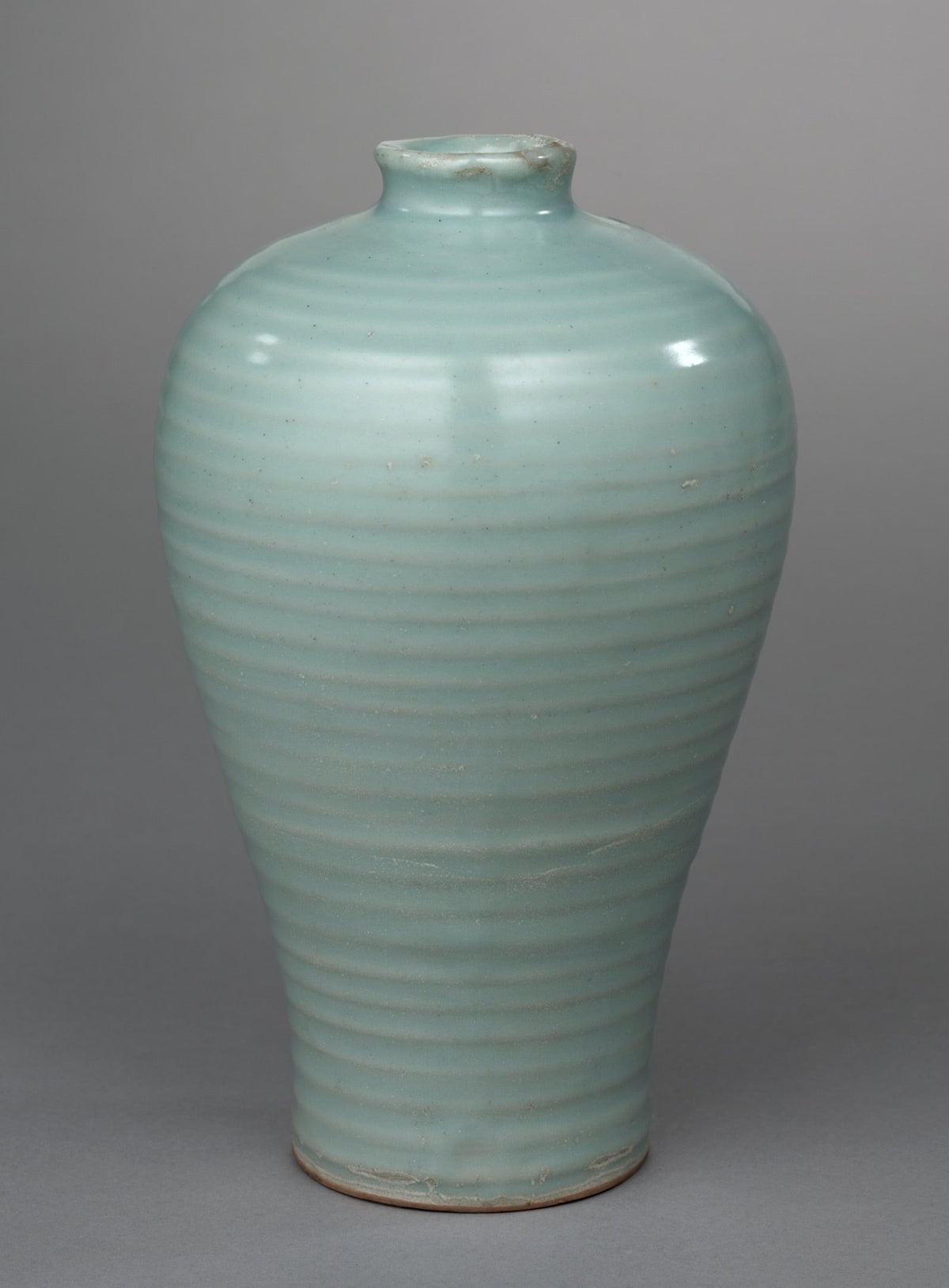 Pale blue-green meiping with a short neck, rounded shoulders and horizontal rings around its tapering body