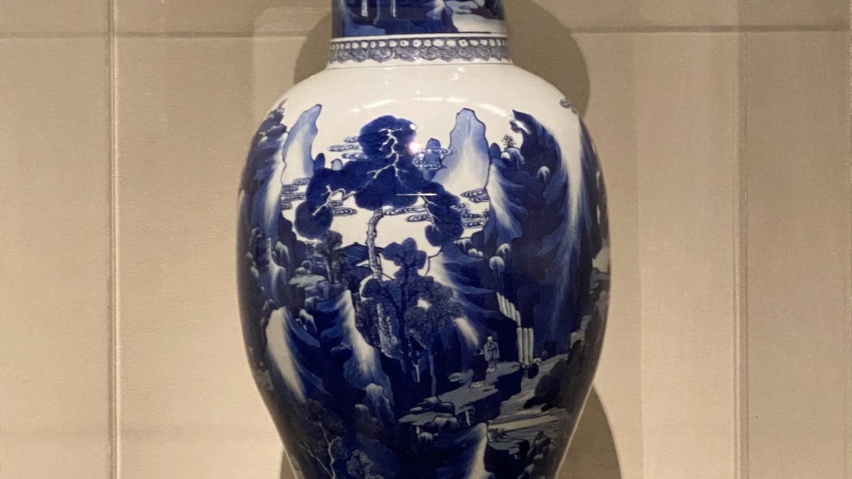 Kangxi-period blue-and-white landscape vase detail with dark cobalt outlines and paler washes