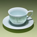 Pale blue-green porcelain coffee cup with horse-and-cloud decoration on its matching saucer.