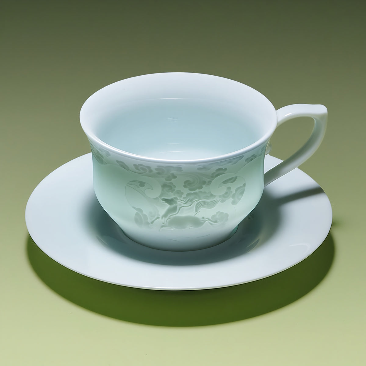 Pale blue-green porcelain coffee cup with horse-and-cloud decoration on its matching saucer.