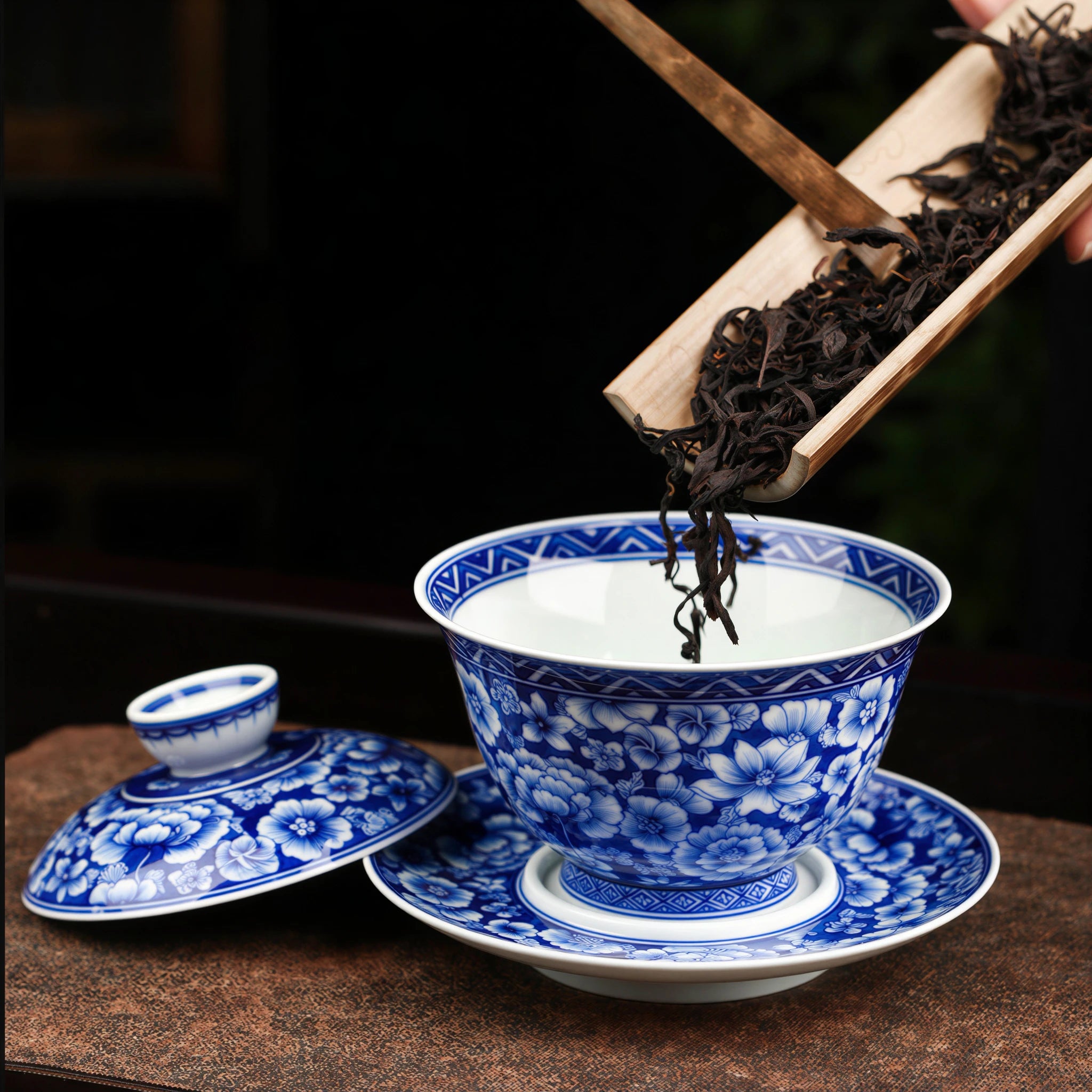 Tea leaves being added to the open millefleurs gaiwan
