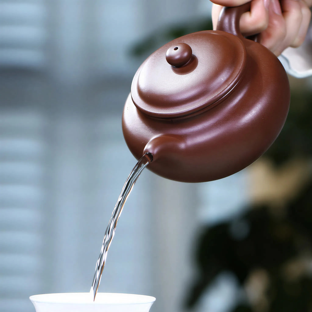 Tea pouring from the 275 ml Fanggu Yixing teapot