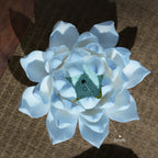 Azure blue lotus incense holder displayed on a wood table