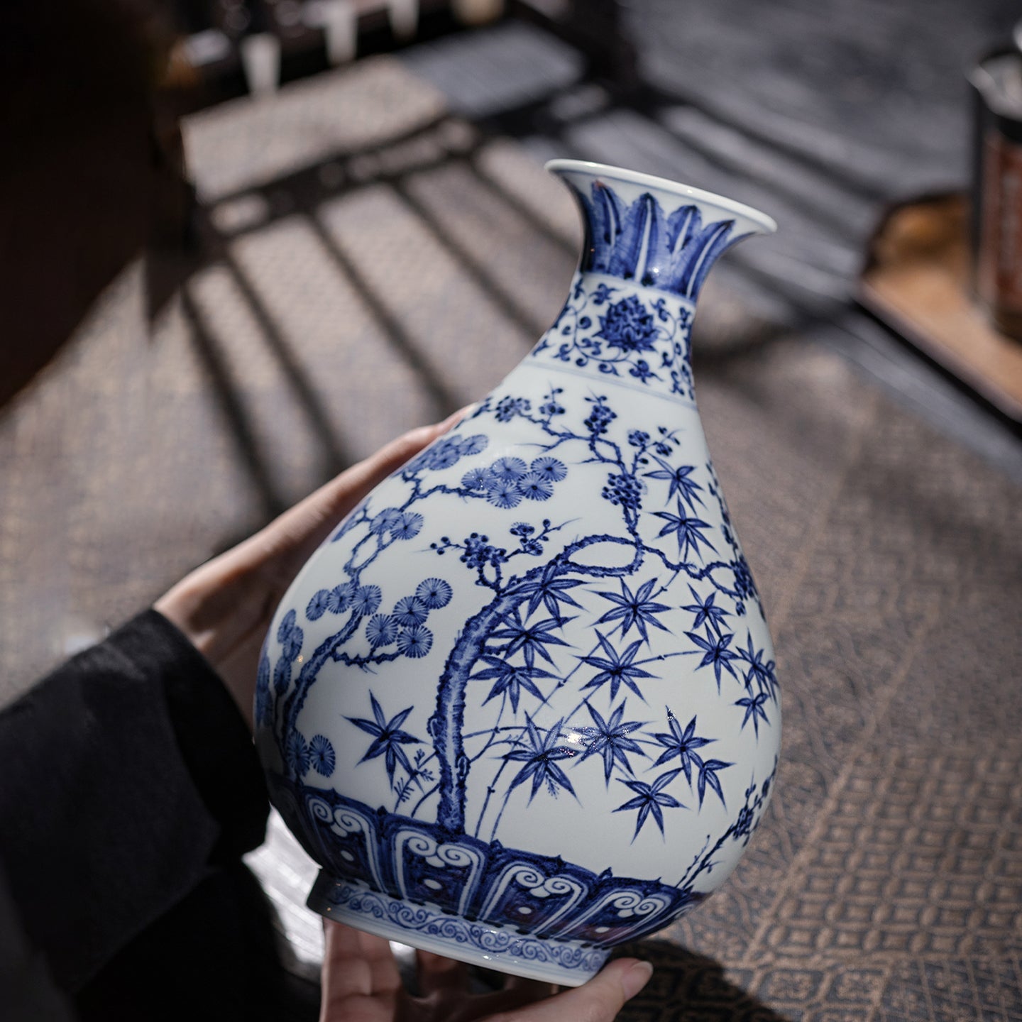 Angled profile of a blue-and-white Yuhuchun vase showing its pear-shaped body and flared mouth