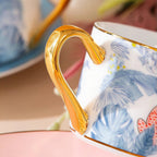 Gold-toned handle detail on the botanical leopard coffee cup