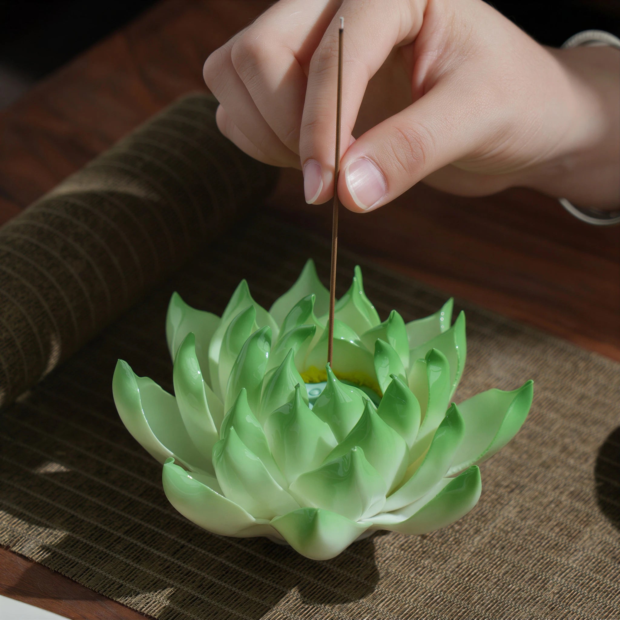 Celadon green porcelain lotus incense holder on a tea table