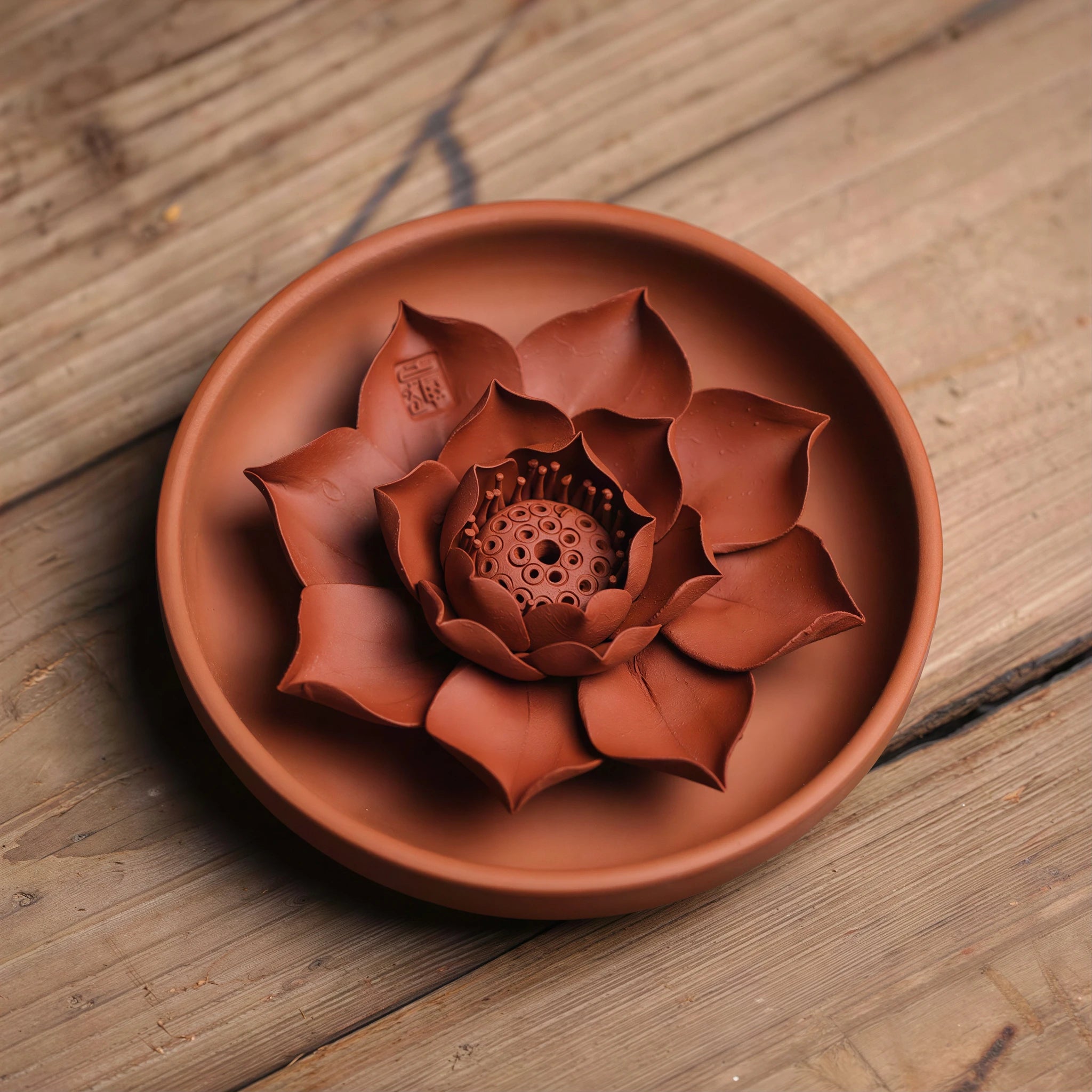 Zhuni lotus and matching plate displayed on a wood tea table