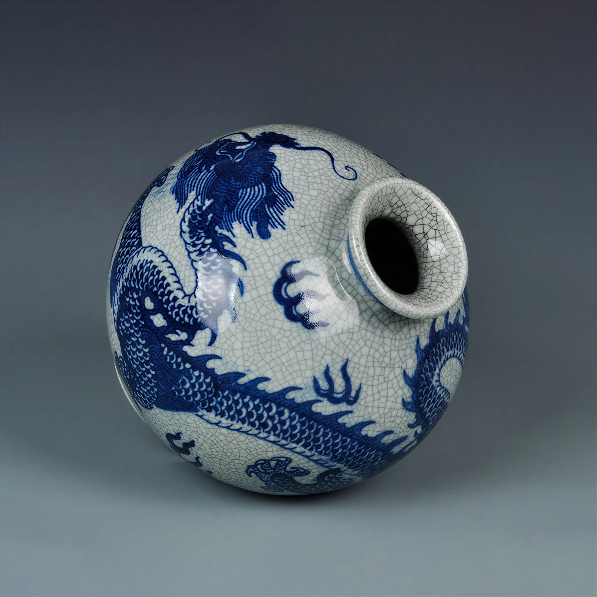 Close view of the cobalt-blue dragon wrapping around the globular crackle-glazed body