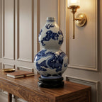 Cobalt dragon double-gourd vase displayed on its wooden stand on a walnut entryway console