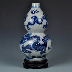 Full view of the cobalt dragon double-gourd vase on its fitted dark wooden stand