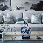 Cobalt dragon crackle vase displayed on its wooden stand in a contemporary living room
