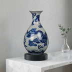 Cobalt dragon Yuhuchun vase displayed on its wooden stand in a living room
