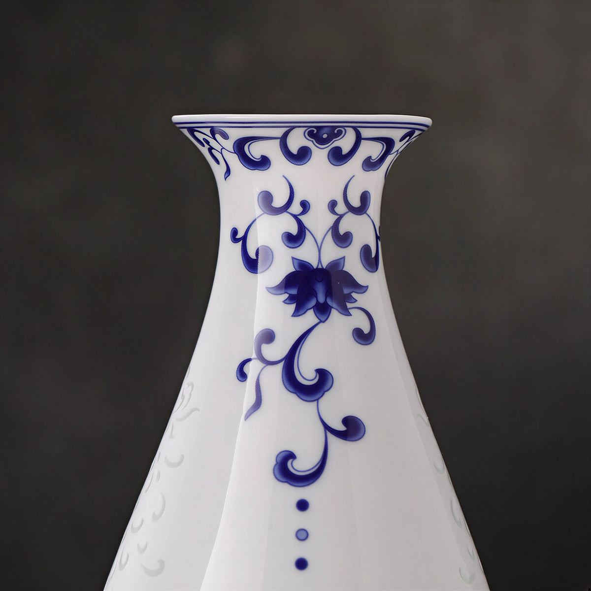 Close view of the cobalt lotus scroll along the neck of the Guanyin vase