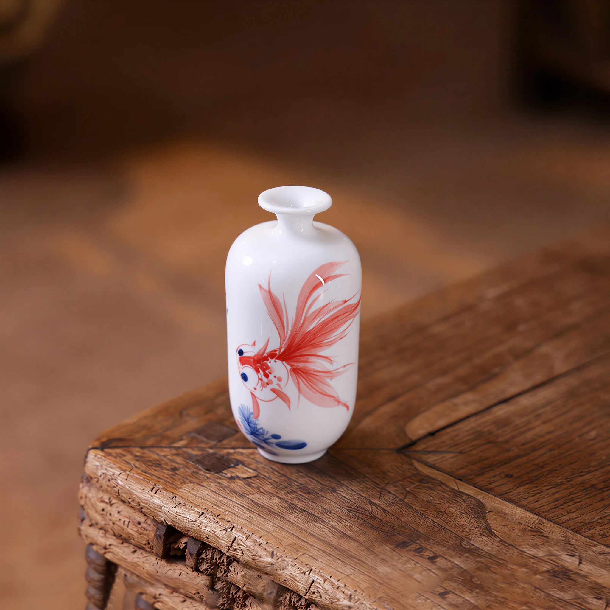 Compact ovoid Donggua vase with hand-painted goldfish on white porcelain
