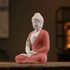Three-quarter view of the coral red and white seated Amitabha Buddha
