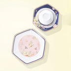 Blush-pink large plate beside a navy floral plate holding the inverted white porcelain rice bowl.