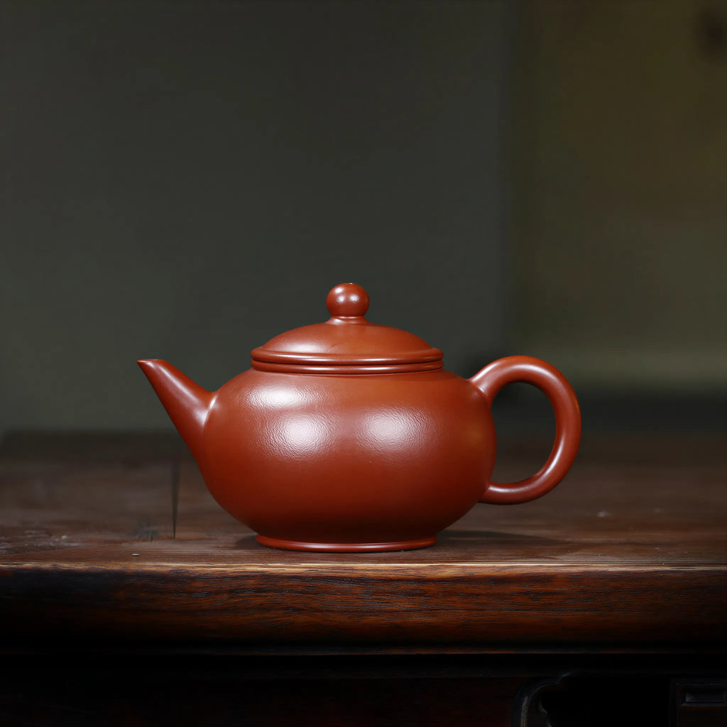 Pear-skin Da Hong Pao Shui Ping teapot on a wood tea table