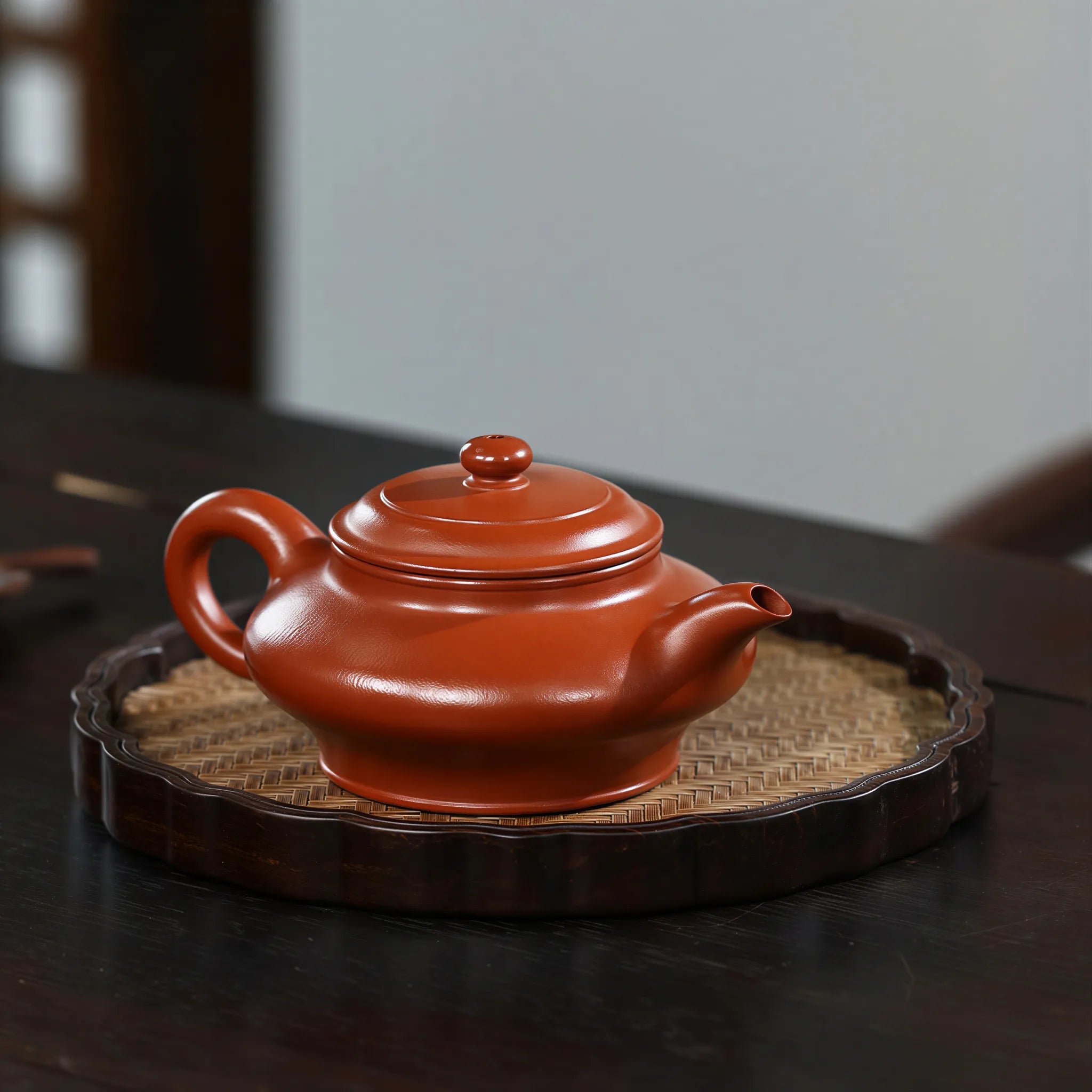 Angled Xu Bian teapot on a woven bamboo mat