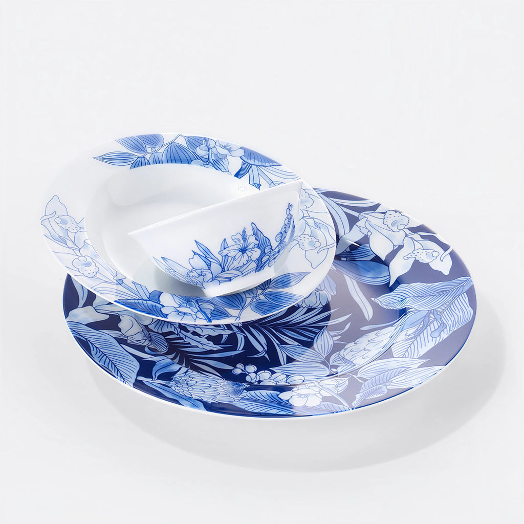 Nested Deep Forest porcelain plates and bowl showing dense and open blue botanical patterns.