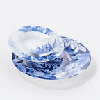 Nested Deep Forest porcelain plates and bowl showing dense and open blue botanical patterns.