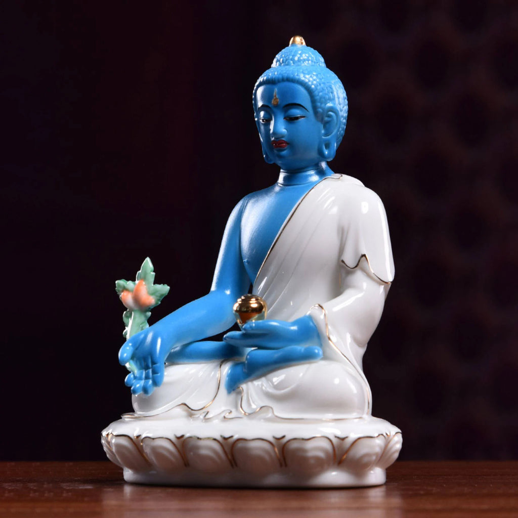 Angled view of the blue Medicine Buddha holding the medicinal plant
