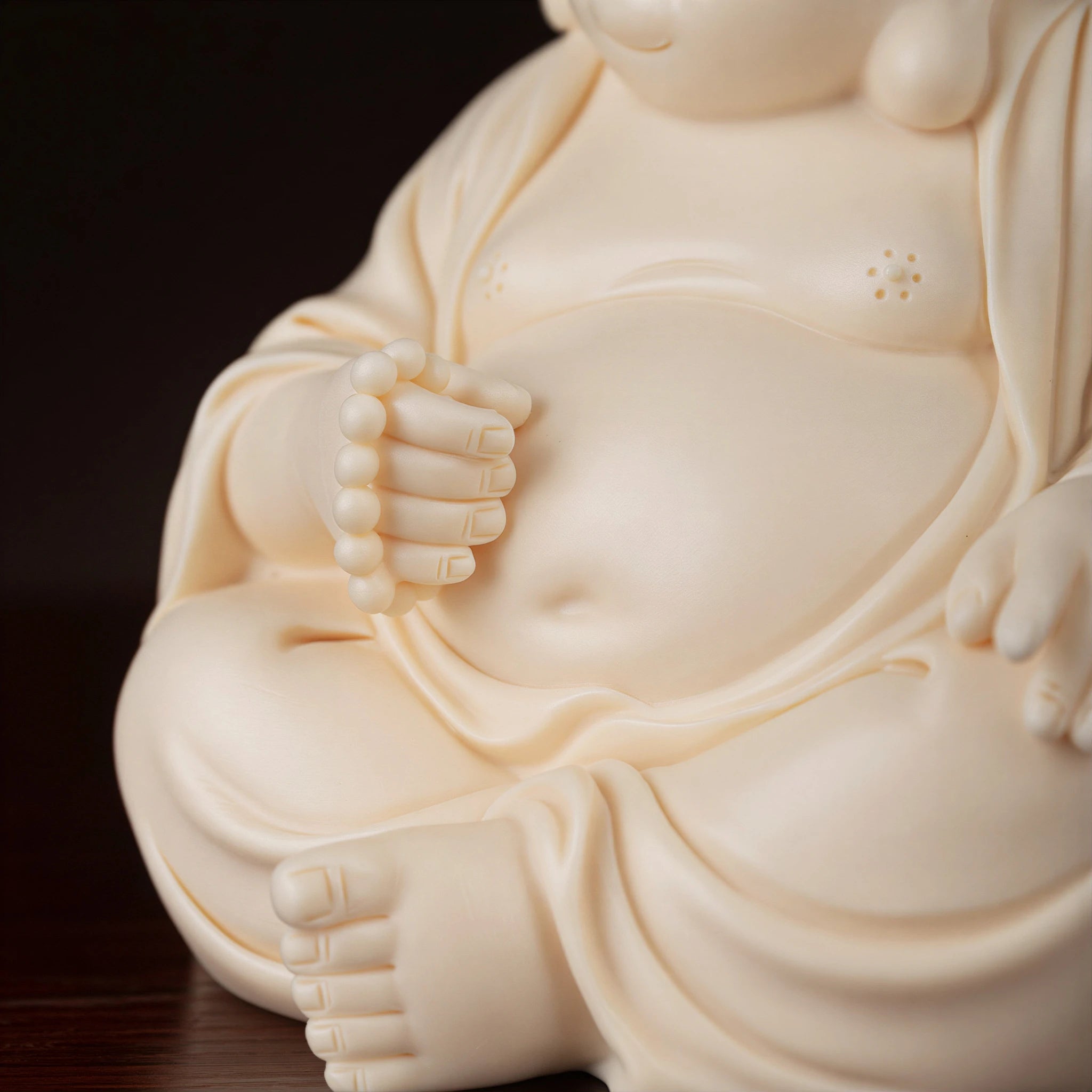 Detail of the prayer beads held by Budai