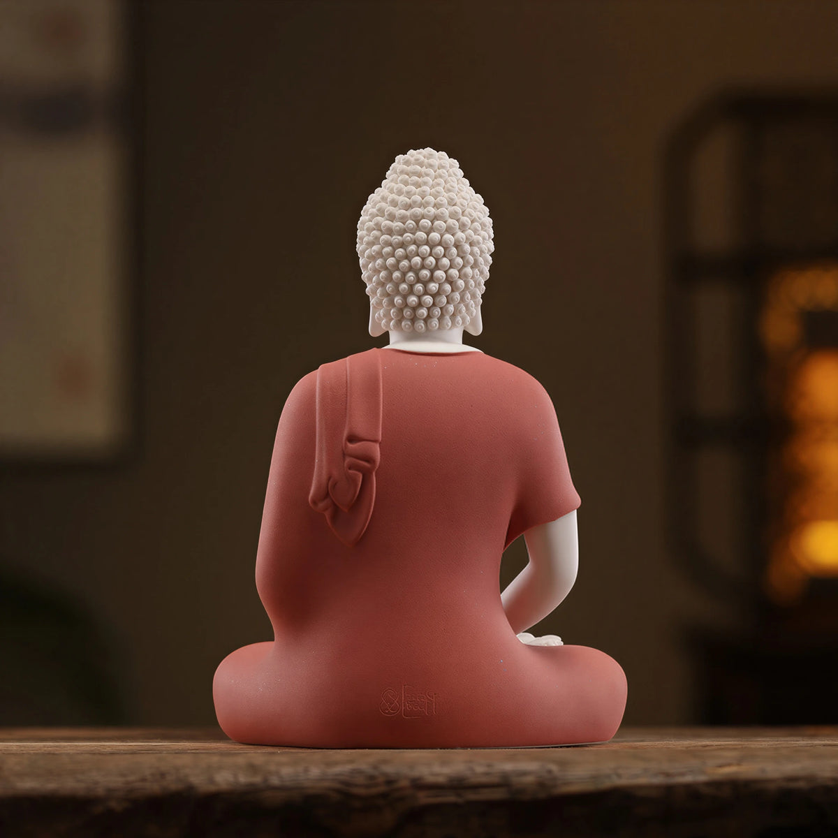 Back view of the coral Amitabha sculpture with an impressed workshop-style mark