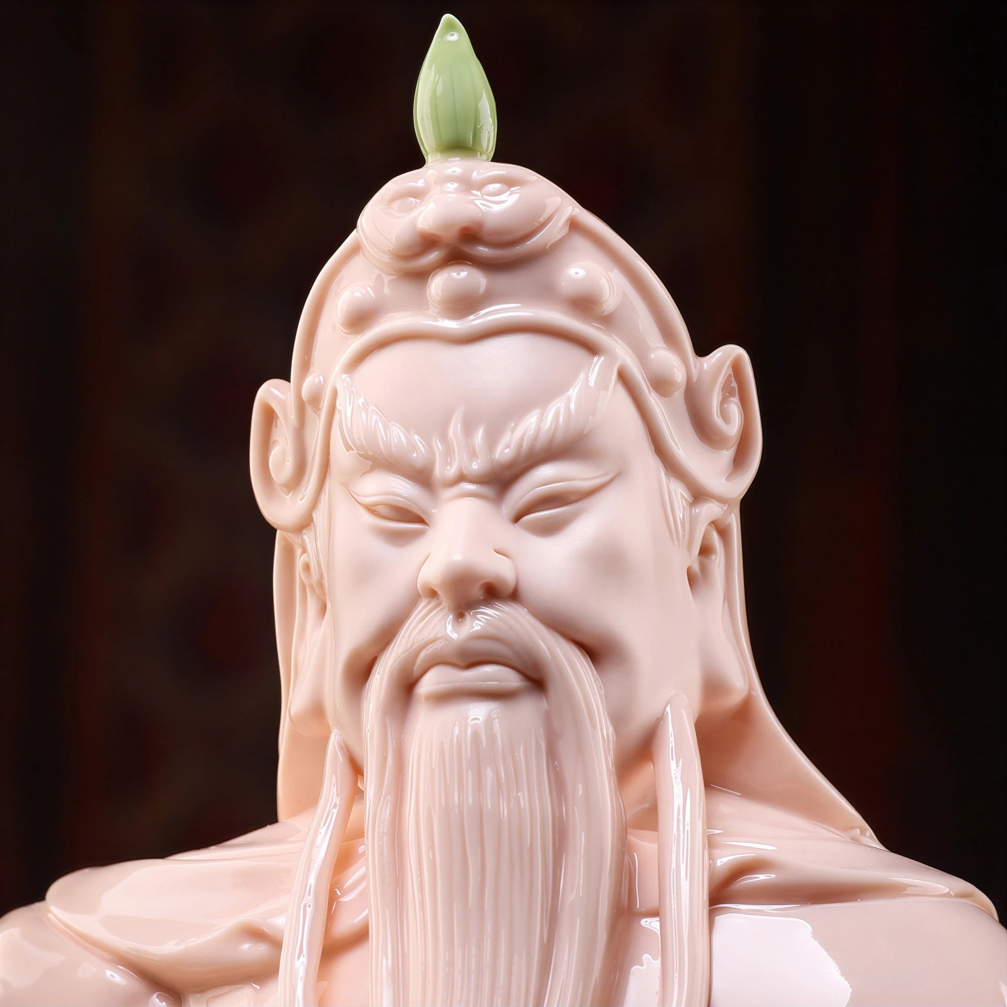 Close view of the Guan Gong face and dark beard against crimson glaze