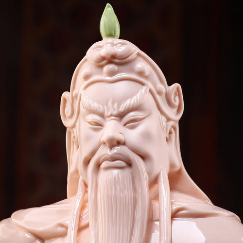 Close view of the Guan Gong face and dark beard against crimson glaze