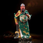 Emerald-robed Guan Gong sculpture shown under directional light