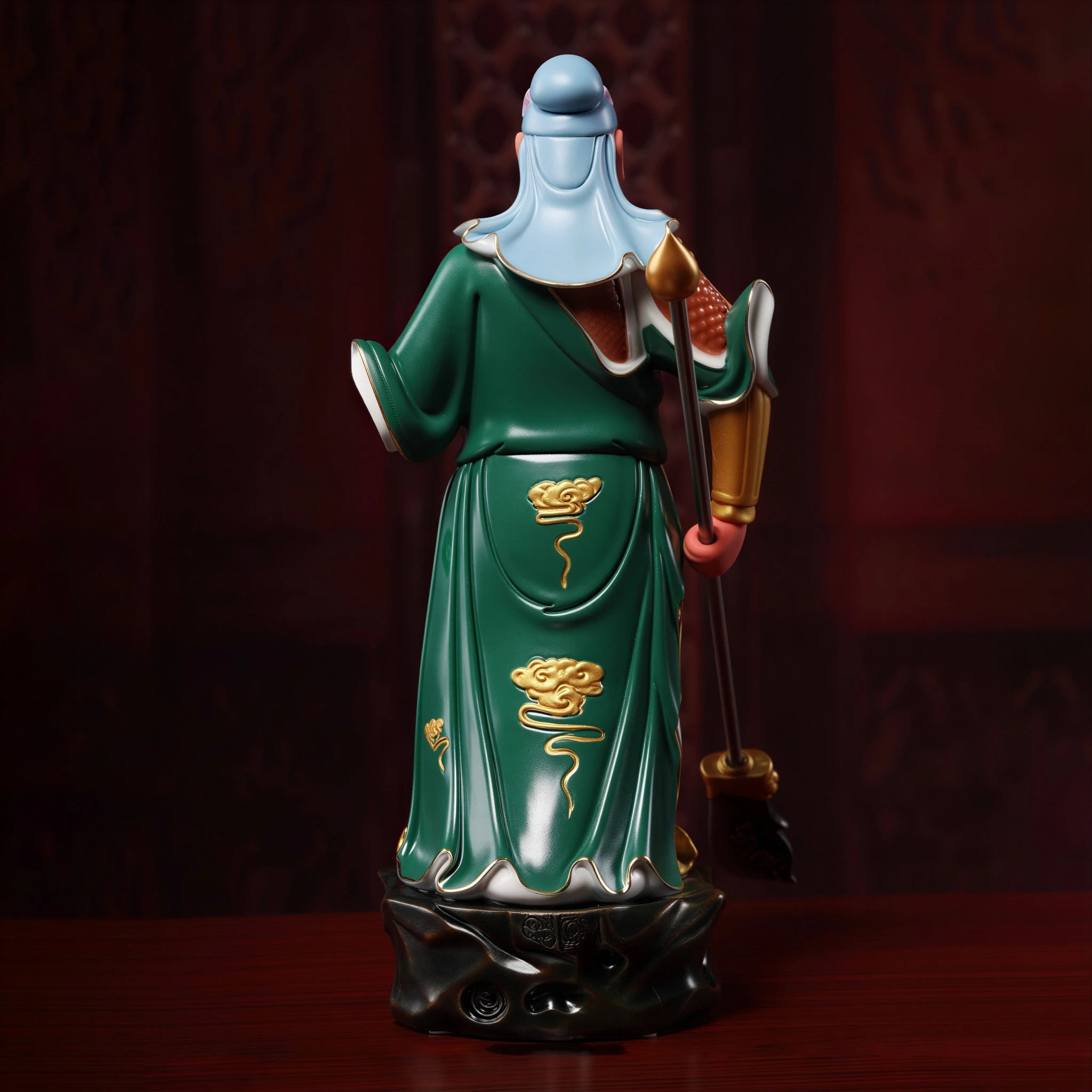 Rear view of the flowing emerald robe and ceramic base