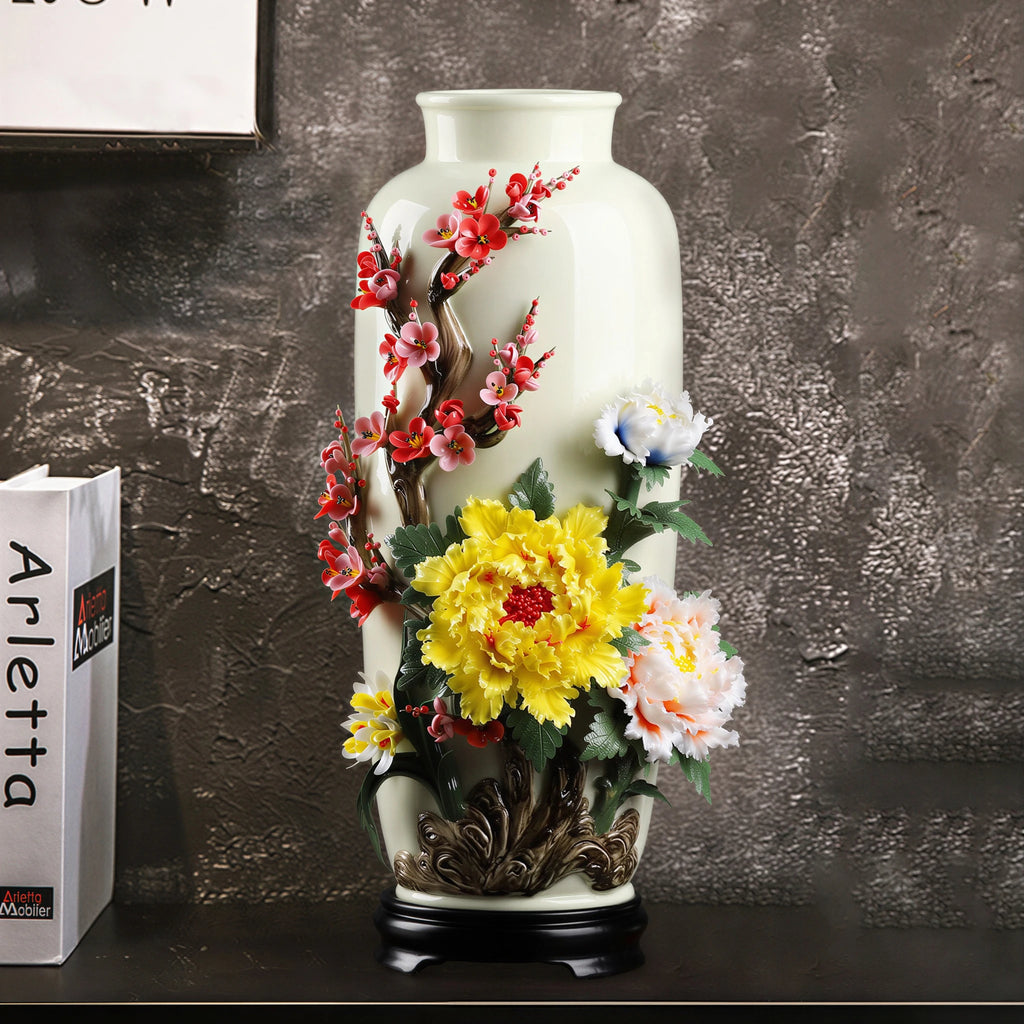 Tall floral relief porcelain vase displayed on a dark sideboard