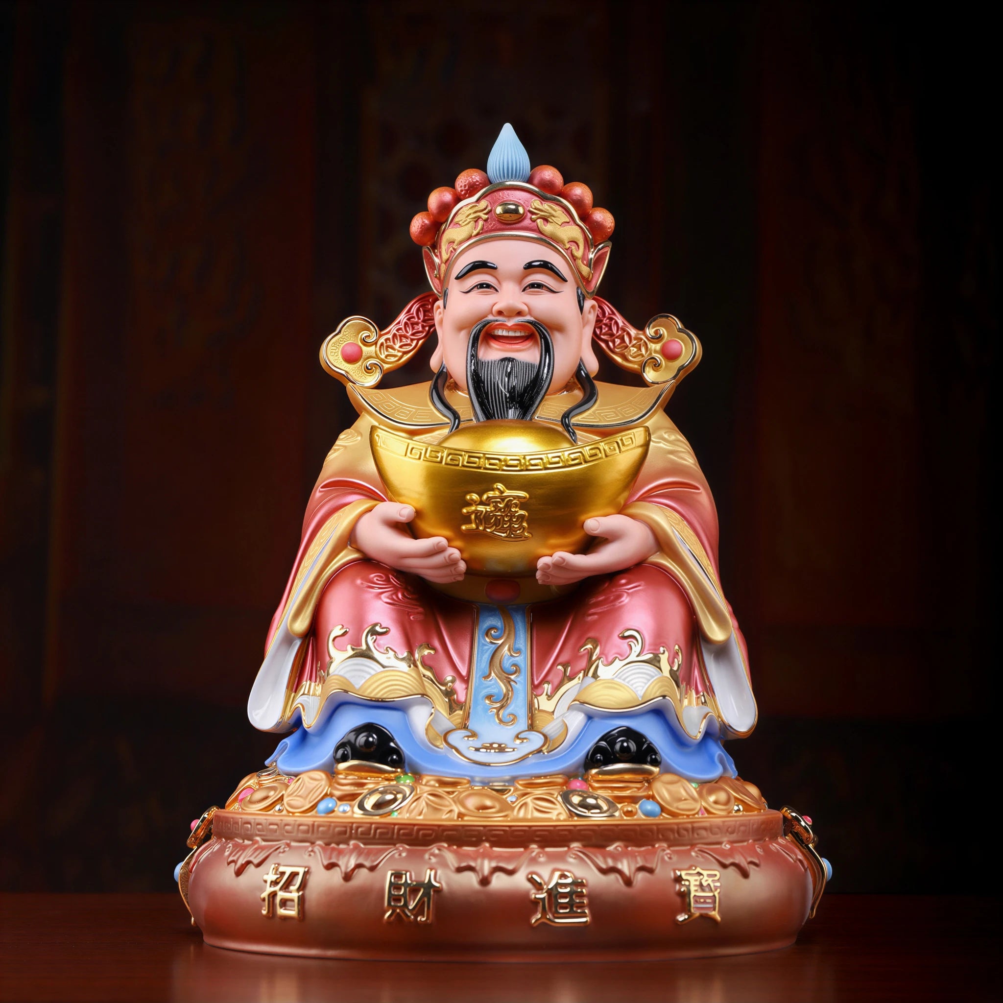 Front view of the pearl-red Fu Bao Caishen porcelain sculpture