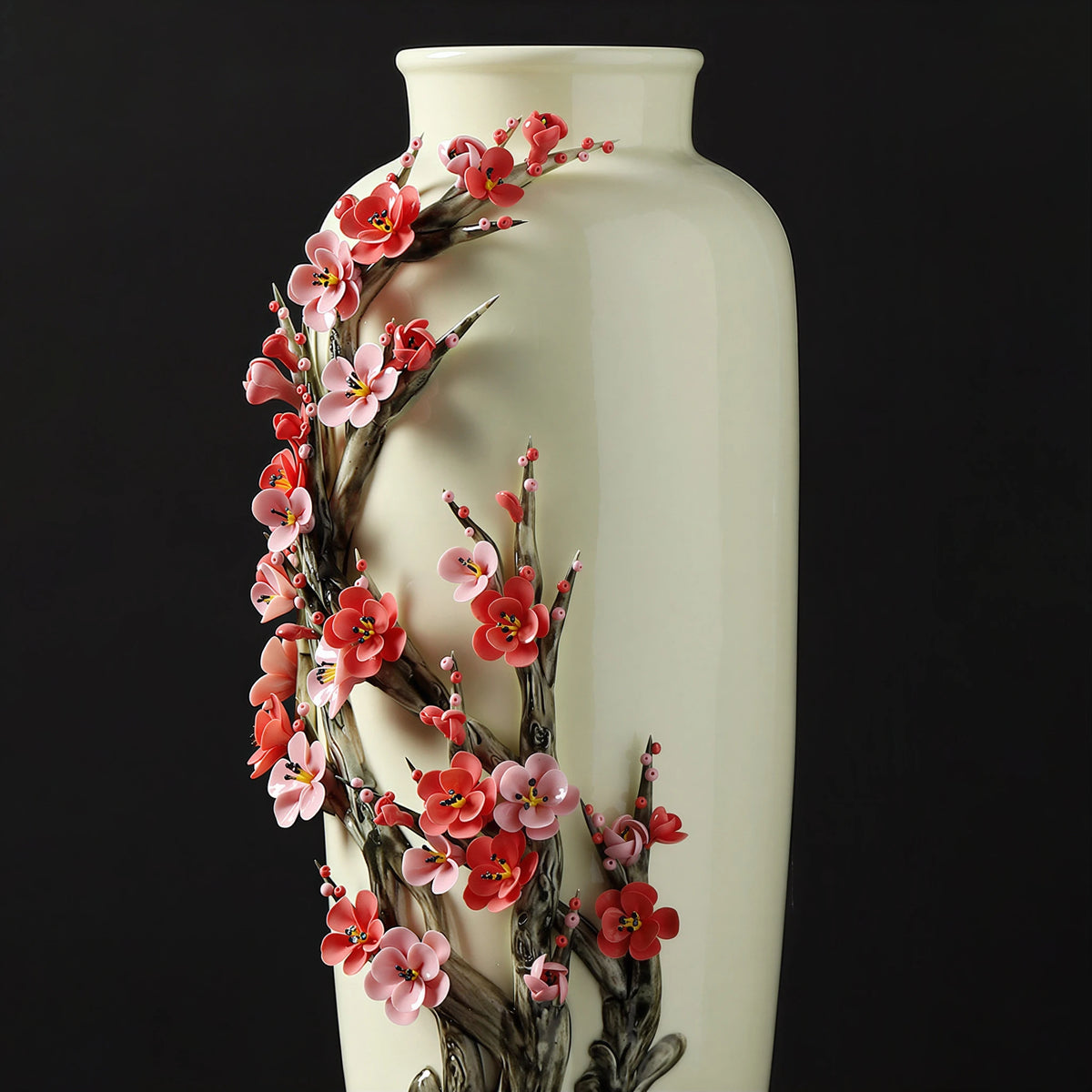 Close angled view of the full plum tree relief across the porcelain vase