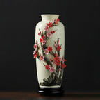 Full view of the tall Dehua vase with a plum tree rising from the foot