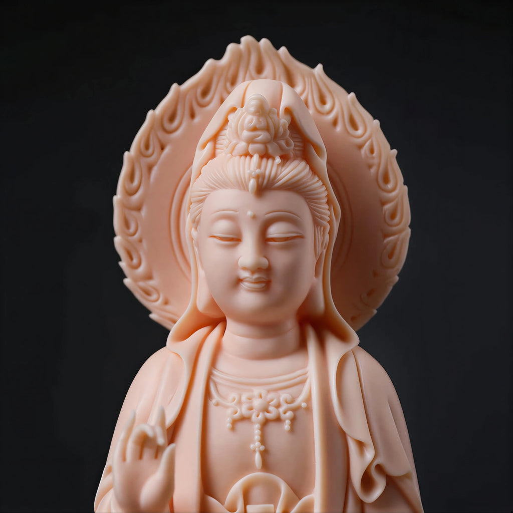 Close view of the Guanyin face and carved mandorla in warm blush porcelain