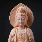 Close view of the Guanyin face and carved mandorla in warm blush porcelain