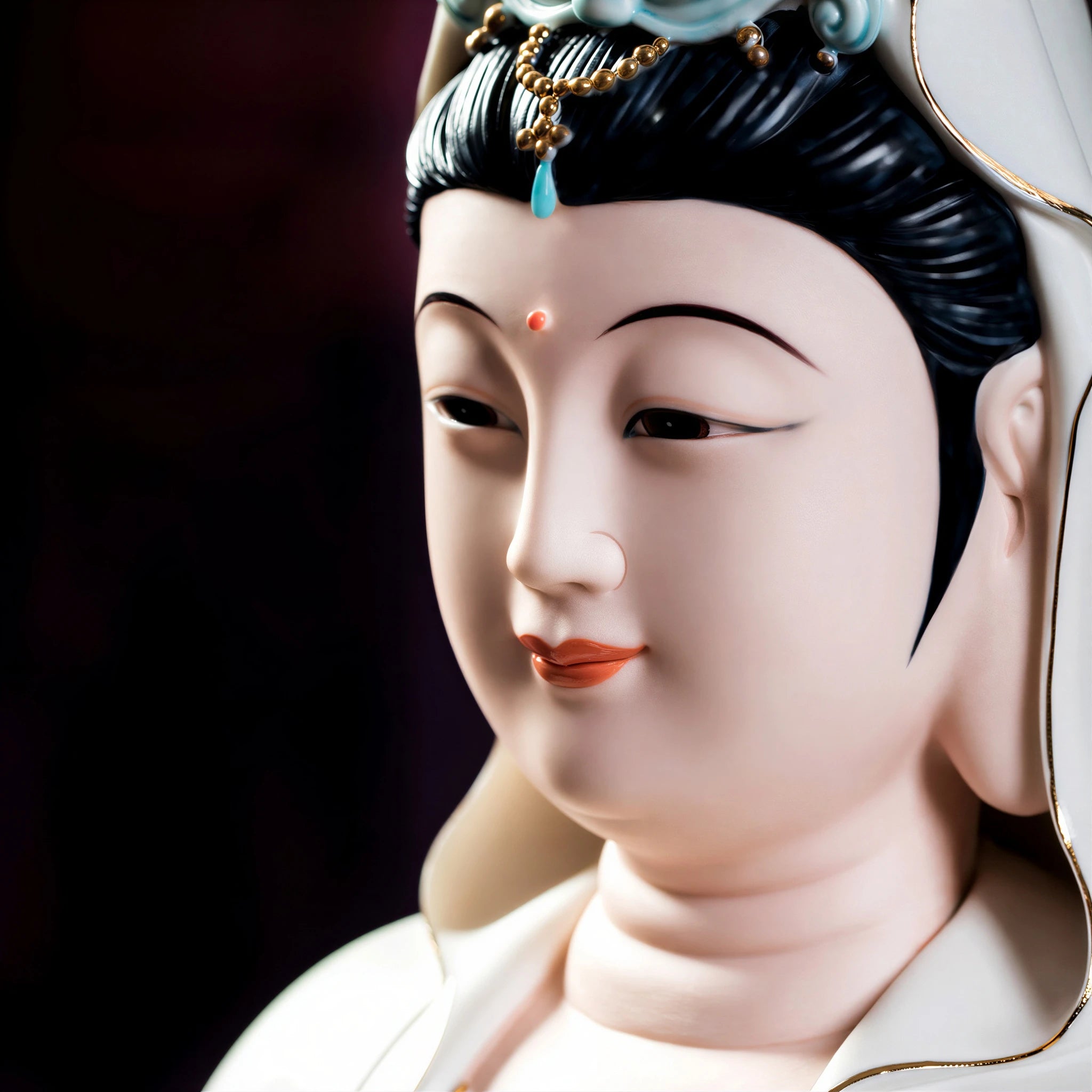 Close view of the Guanyin face and gold-toned details