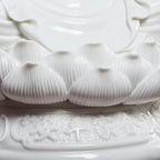Layered lotus pedestal relief in white Dehua porcelain
