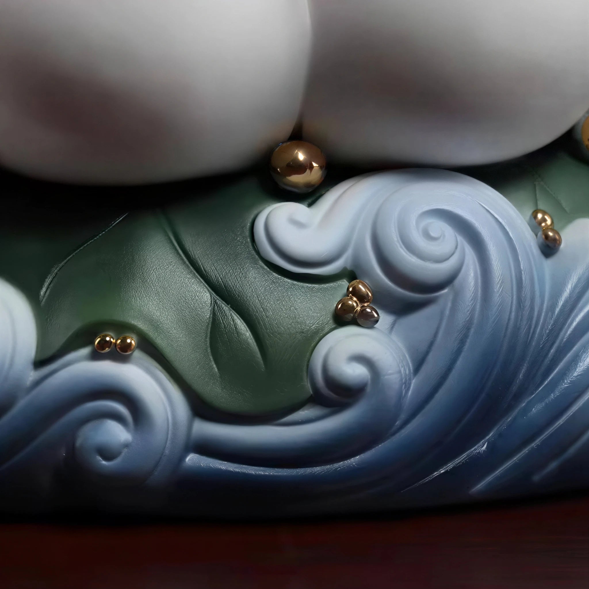 Lotus-and-wave base with restrained gold-toned details
