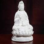 Seated white porcelain Guanyin on a layered lotus pedestal