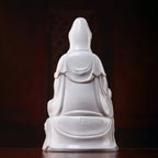 Rear view of the flowing robes on the white porcelain Guanyin