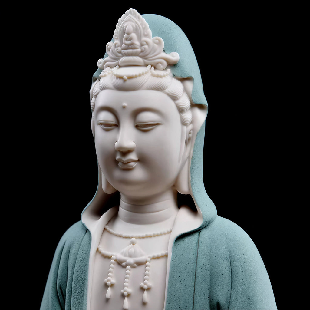 Close view of the hooded Guanyin face and quiet downward gaze