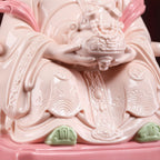Detail of the rose-glazed robe and gold-toned decoration