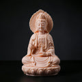 Front view of a jade-red Dehua porcelain Guanyin seated before a flame-shaped halo