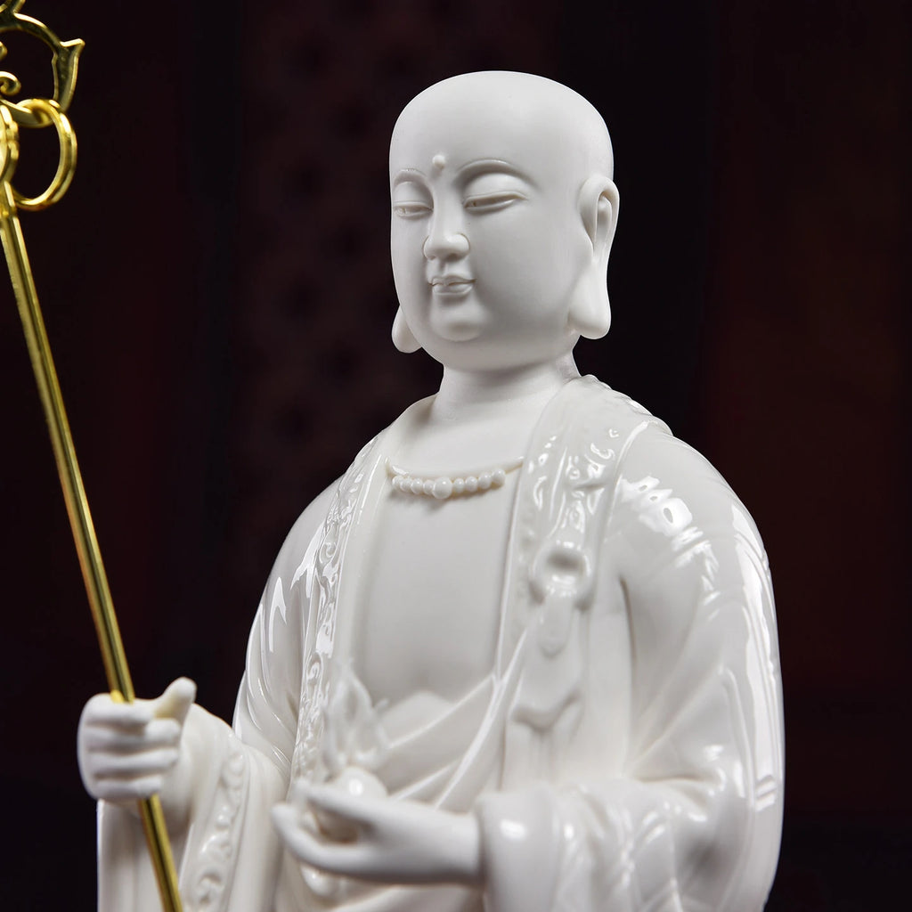 Close view of the Ksitigarbha face and gold-toned monk's staff