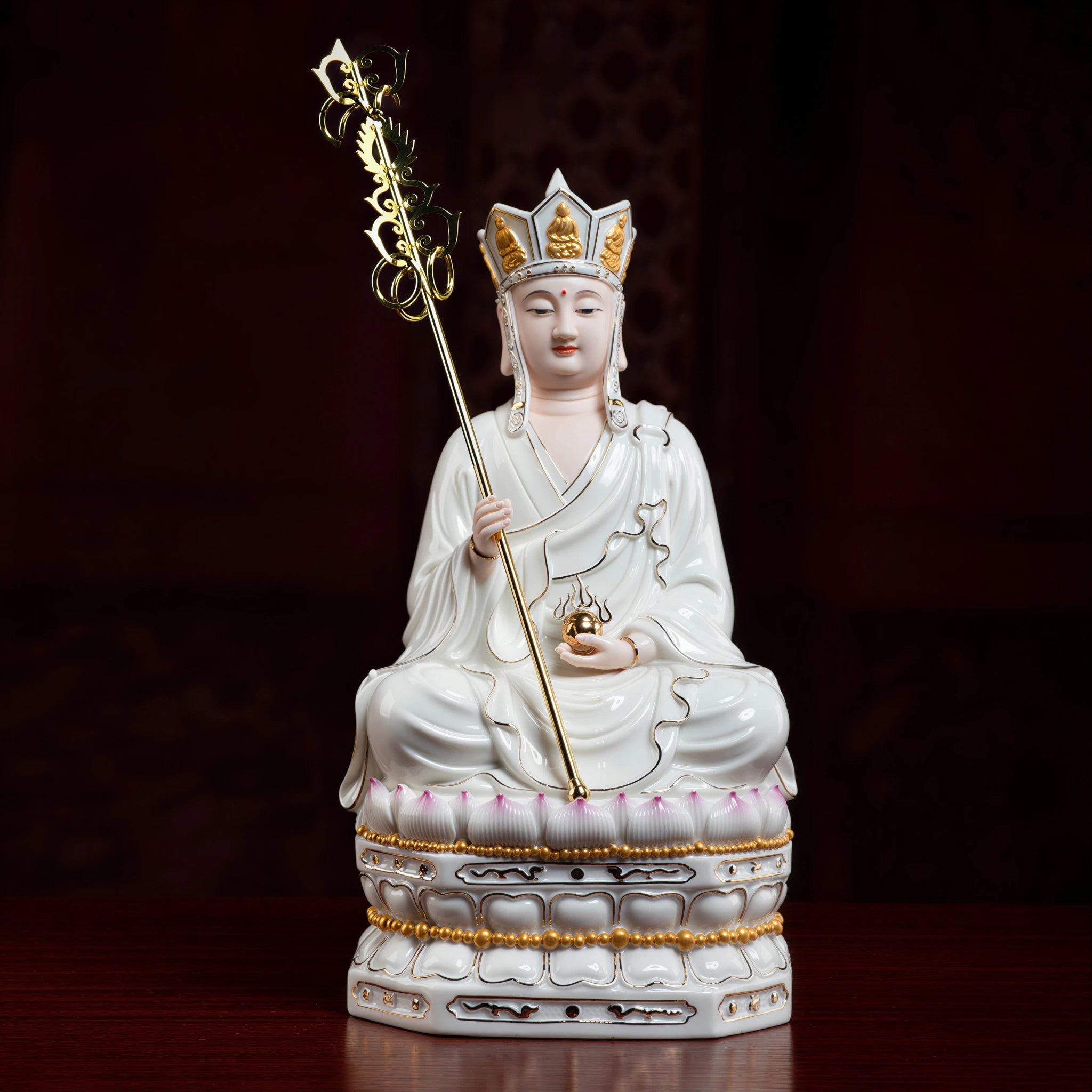 Gold-traced polychrome Ksitigarbha on a tiered lotus pedestal