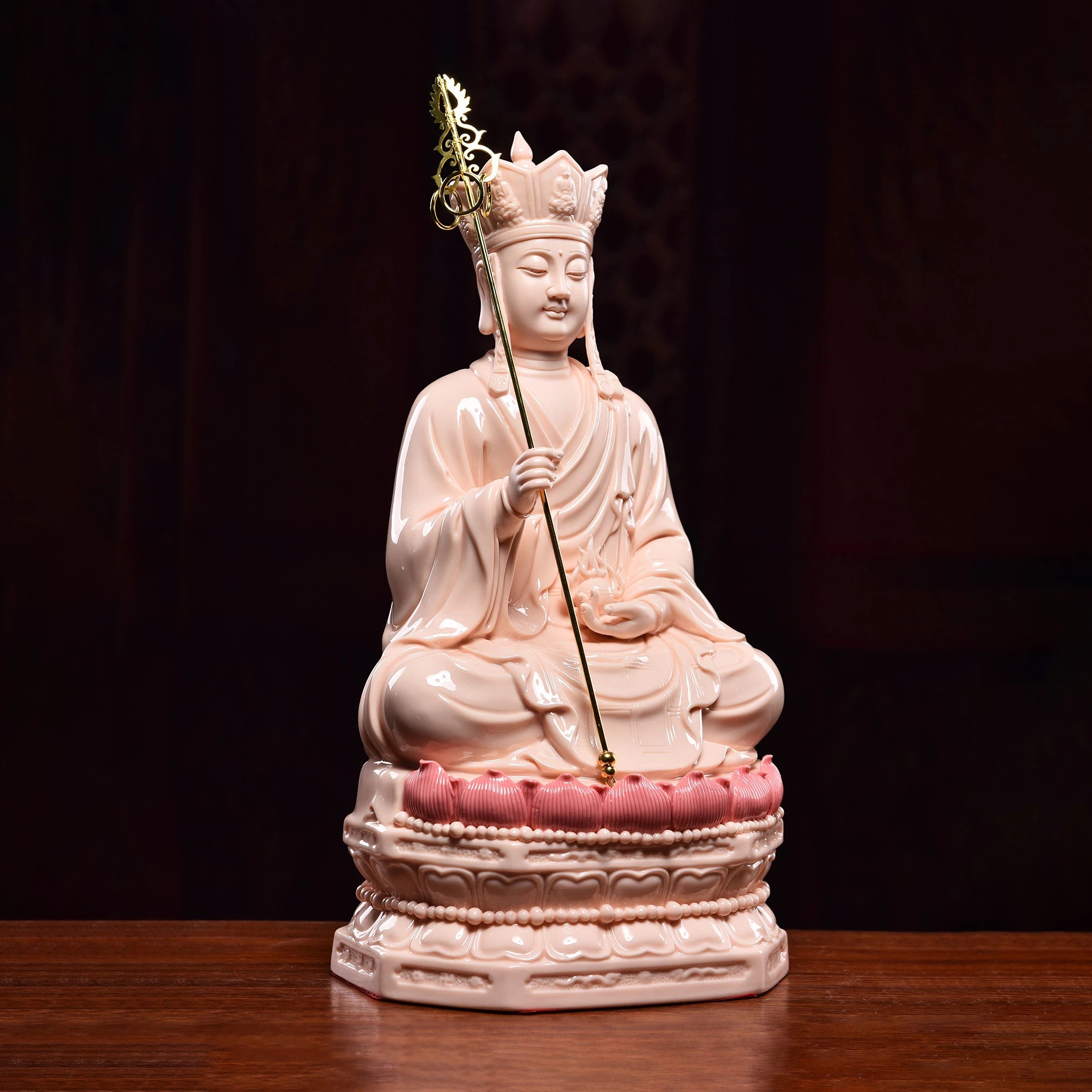 Three-quarter view of the red-glazed Ksitigarbha sculpture