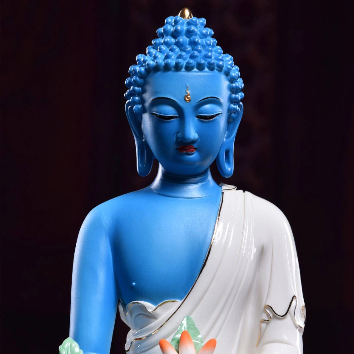 Close view of the lapis-blue Medicine Buddha face and glaze