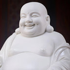 Close view of the smiling face and modeled features of the Dehua Maitreya